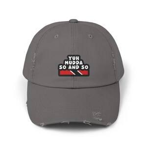 May include: A gray distressed baseball cap with the text "Yuh mudda so and so" and a Jamaican flag design.