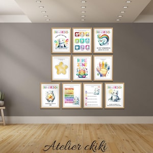 May include: A collection of framed art prints with whimsical illustrations and text. The prints feature colorful designs, including a star, handprints, and cartoon characters. The artwork is displayed on a gray wall above a wooden floor.