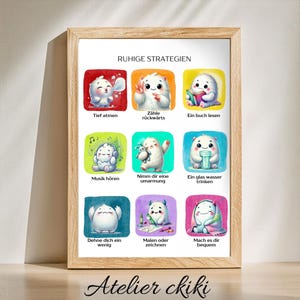 May include: A framed print featuring colorful illustrations of cute, fluffy creatures demonstrating calming strategies. The print includes German text such as "Tief atmen" and "Ein buch lesen". The bottom of the frame has the text "Atelier ckiki".