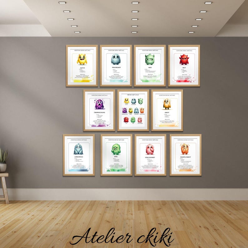 May include: A collection of framed art prints featuring colorful cartoon monster illustrations. Each print has a unique monster design with a corresponding name. The prints are displayed on a gray wall above a wooden floor.