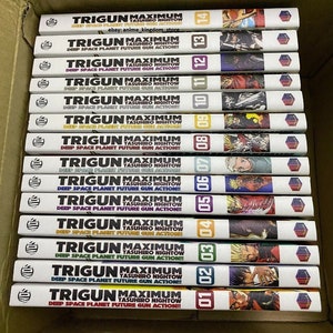May include: A complete set of 14 volumes of the Trigun Maximum manga series by Yasuhiro Nightow. The spines of the books are all black with white text and feature the title "Trigun Maximum" and the author's name. The books are arranged in order from volume 1 to volume 14.