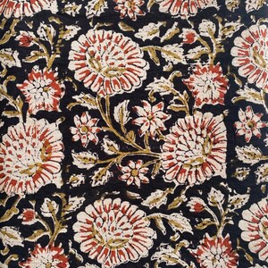 May include: Black fabric with a floral pattern in shades of red, white, and brown. The flowers are stylized and have a vintage look.