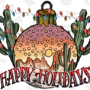 以下が含まれることがあります： 砂漠の風景とサボテンが描かれたクリスマスオーナメント。オーナメントはレオパード柄で飾られており、赤い「Happy Holidays」の文字が書かれています。