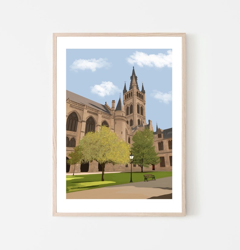 May include: A framed illustration of a large, stone building with a tall tower. The building has a pointed roof and arched windows. There are trees and a bench in front of the building. The sky is blue with white clouds.