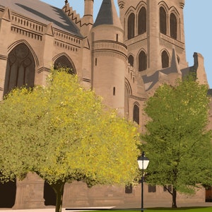 May include: A large, stone building with a tall tower and several windows. Two trees are in front of the building, one with green leaves and one with yellow leaves. A lamppost is in the foreground.