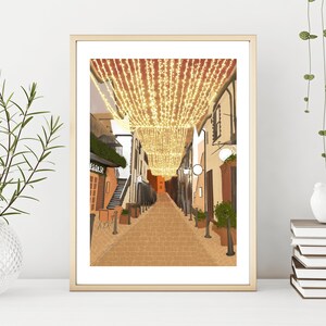 May include: A digital illustration of a narrow street lined with buildings, decorated with string lights. The street is paved with brick and the buildings are painted in warm tones.