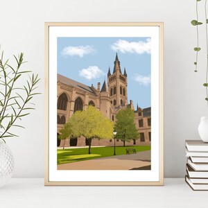 May include: A framed illustration of a large, beige building with a tall tower and a blue sky with white clouds. There are green trees in front of the building and a lamppost in the center.