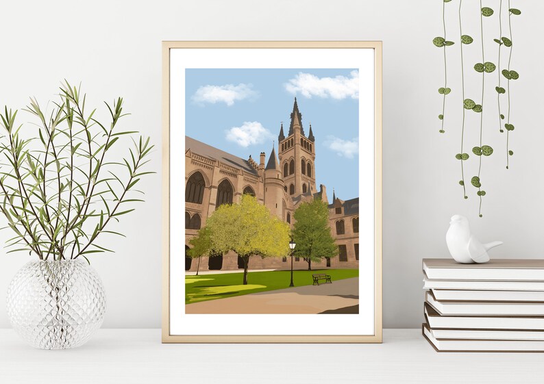 May include: A framed illustration of a large, beige building with a tall tower and a blue sky with white clouds. There are green trees in front of the building and a lamppost in the center.