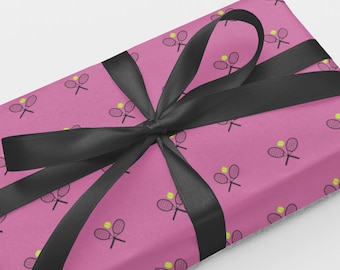 May include: Pink gift wrap with a black ribbon and a repeating pattern of tennis rackets and tennis balls.