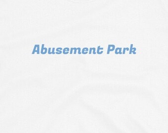May include: White t-shirt with the text "Abusement Park" in blue lettering.