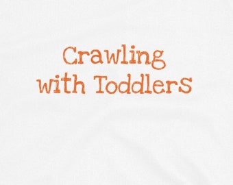 May include: White short-sleeved t-shirt with the text "Crawling with Toddlers" printed in orange.