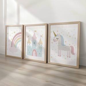 Pu&ograve; includere: Tre stampe artistiche incorniciate con un arcobaleno, un castello e un unicorno. Le stampe hanno una cornice in legno chiaro, con uno sfondo bianco e un motivo a stelle. L'arcobaleno &egrave; pastello, il castello &egrave; blu e rosa, e l'unicorno &egrave; bianco con criniera blu e coda rosa.