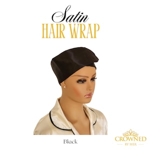 May include: A black satin hair wrap is displayed on a mannequin. The words "Satin Hair Wrap" are above the wrap. The word "Black" is below the wrap. The mannequin is wearing a cream-colored satin pajama top.
