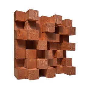May include: A wall-mounted sound diffuser made of natural wood blocks. The blocks are arranged in a random pattern, creating a unique and modern look. The diffuser is designed to help reduce sound reflections and improve acoustics in a room.