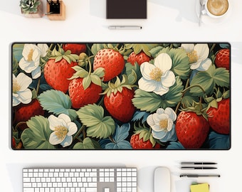 May include: A colorful mousepad with a design of red strawberries and white flowers on a green leafy background.