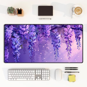 May include: Purple wisteria flowers hanging from a branch with a soft purple background. The flowers are in bloom and have a delicate, feminine look.