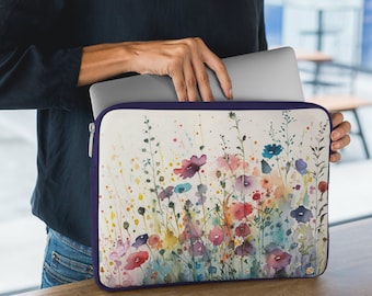 May include: A laptop sleeve with a watercolor design of colorful flowers on a white background. The sleeve has a purple zipper and is made of a durable material.
