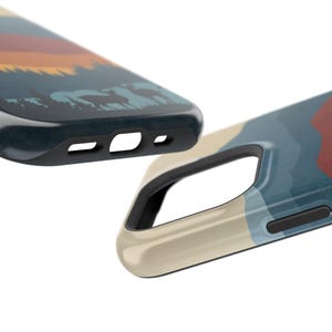 May include: Two phone cases featuring a mountain landscape design. The case on the left is blue and depicts a sunset scene. The case on the right is beige and features a blue and red mountain scene.