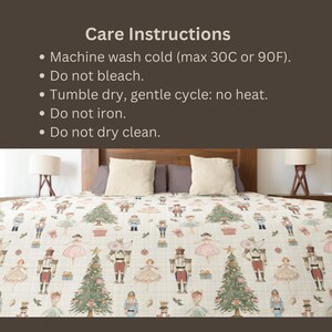 May include: A bedspread featuring a repeating pattern of nutcrackers, ballerinas, mice, and Christmas trees on a light grid background. Above the bed, text reads: Care Instructions: Machine wash cold (max 30C or 90F). Do not bleach. Tumble dry, gentle cycle: no heat. Do not iron. Do not dry clean.