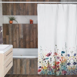 May include: White shower curtain with a watercolor floral design featuring colorful flowers and greenery. The flowers are arranged in a row at the bottom of the curtain.