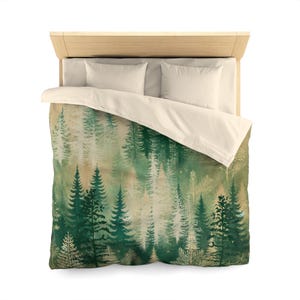 May include: A duvet cover with a forest scene featuring a watercolor-style pattern of green trees on a beige background.