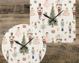 May include: A square wall clock and a round wall clock featuring a repeating pattern of nutcrackers, ballerinas, mice, and Christmas trees on a cream grid background. Both clocks have black hour and minute hands centered on the clock faces.