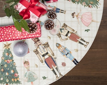 May include: A circular Christmas tree skirt featuring a white and beige plaid pattern with watercolor illustrations of nutcrackers, ballerinas, and decorated pine trees. The fabric is adorned with pinecones, gift boxes, and ornaments.