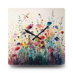 May include: A watercolour painting of a field of colourful wildflowers with a dragonfly and a butterfly. The painting is on a square clock face with black hands.