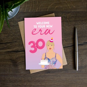 May include: A pink and purple greeting card with a pink balloon shaped like the number 30. The card says "Welcome to your new era" and features a cartoon illustration of a woman wearing a sparkly dress and a party hat holding a birthday cake.