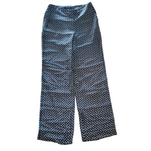 May include: Black and white patterned wide-leg pants. The pants have a small, white floral print on a black background.