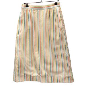May include: A high-waisted midi skirt featuring a vertical striped pattern in shades of orange, yellow, pink, and teal on a white background. The skirt has a structured waistband, subtle pleats at the top, and a straight silhouette that falls below the knee.