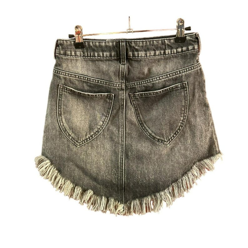May include: A dark grey denim skirt with a frayed hem. The skirt has two back pockets.