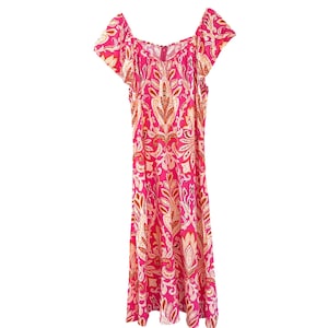 May include: A pink maxi dress with a paisley pattern in shades of orange, white, and pink. The dress has a square neckline and short, ruffled sleeves.