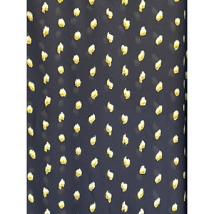 May include: A dark blue fabric with a repeating pattern of small, yellow, irregular shapes.