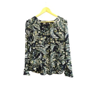 May include: A long-sleeved blouse with a dark blue background and a green and white floral print.