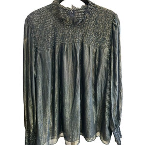 May include: A black and gold striped long-sleeved blouse with a gathered neckline and a slightly loose fit.