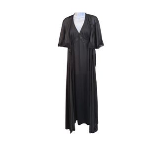 May include: A black vintage nightgown and matching cape. The nightgown has a V-neckline with lace trim and a flowing, floor-length design. The cape has short sleeves and lace detailing. The set is displayed on a white mannequin.