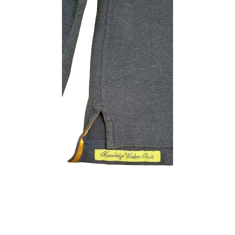 May include: A dark gray long-sleeve shirt with a yellow and orange trim on the side seam. The shirt has a yellow tag sewn on the bottom hem that reads "Knowledge Wisdom Truth".