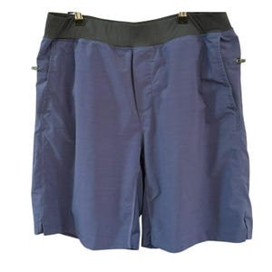 May include: Blue athletic shorts with a black waistband and side pockets.