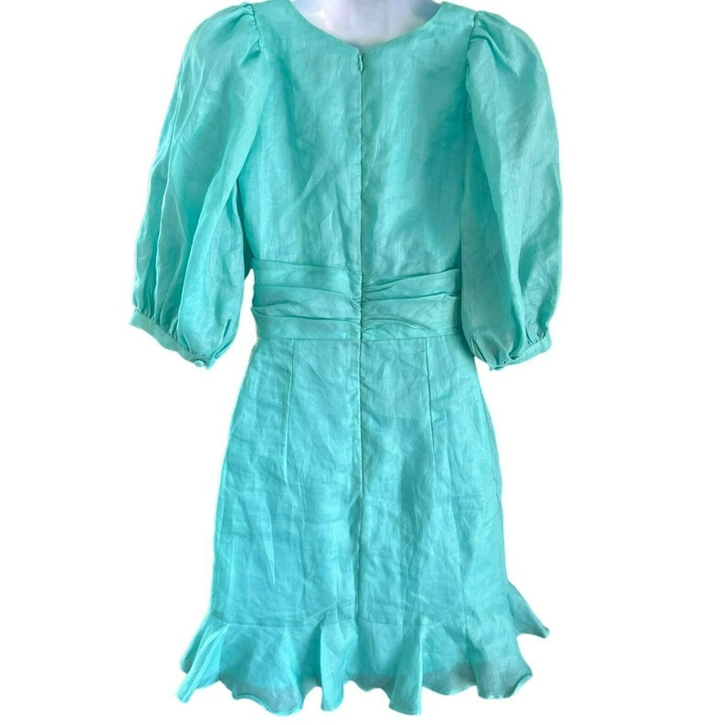 May include: A turquoise blue short-sleeved dress with a ruffled hem and a cinched waist.