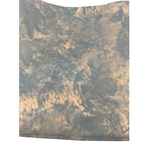 May include: A piece of fabric with a cloudy, tie-dye pattern in shades of blue and cream. The fabric has a textured appearance, with the colors blending together to create a soft, ethereal effect. The top edge is slightly curved.
