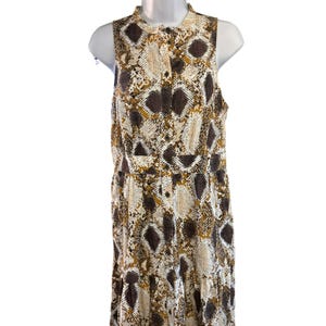 May include: A sleeveless maxi dress with a button-up front and a snake print pattern in shades of brown, white, and gold.