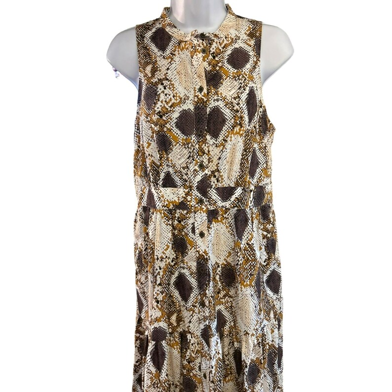 May include: A sleeveless maxi dress with a button-up front and a snake print pattern in shades of brown, white, and gold.