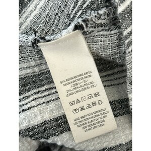 May include: White tag with black text and care instructions. The tag is attached to a black and white striped fabric. The text on the tag reads: 80% Rayon-Rayonne-Rayon-Raion-Kunstseide-Raiom-人造絲・レーヨン 20% Linen-Lin-Lino-Lino-Leinen-Linho-亞麻布・リネン Hand Wash Cold Separately Use Only Non-Chlorine Bleach Reshape & Lay Flat to Dry Low Iron As Needed Do Not Dry Clean