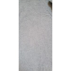 May include: A close-up of a gray heather fabric with a soft, textured surface.