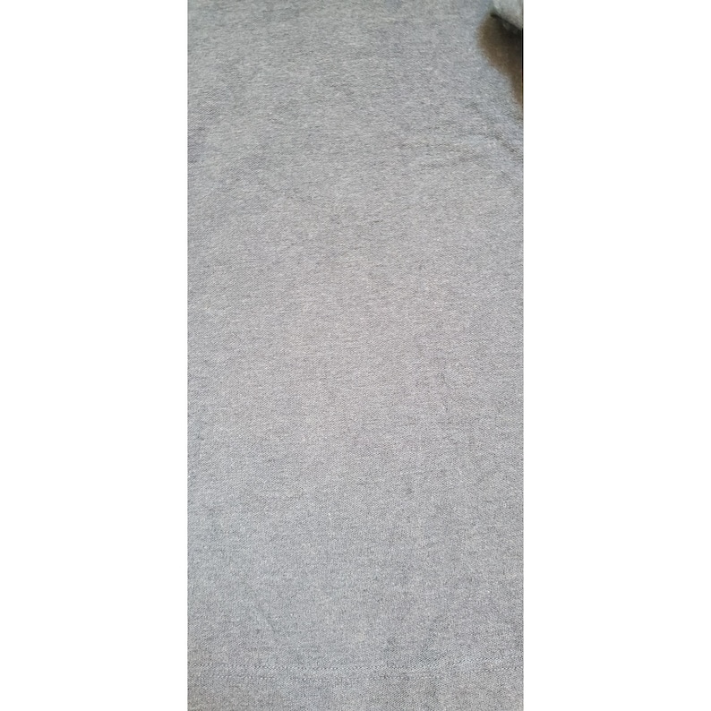 May include: A close-up of a gray heather fabric with a soft, textured surface.