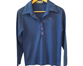 May include: A long-sleeve navy blue polo shirt featuring a wide collar, a three-button placket, and a small embroidered logo on the left chest. The interior neck label displays the text Givenchy Sport. The shirt is displayed on a wooden hanger.