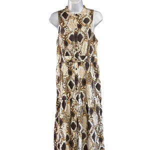 May include: A sleeveless maxi dress with a snakeskin print in shades of brown, white, and gold. The dress has a button-up front and a tiered skirt.