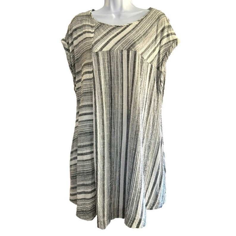 May include: A black and white striped short-sleeved dress with a relaxed fit.