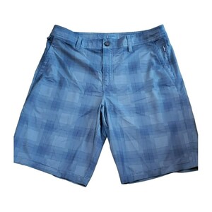 May include: Blue plaid shorts with a zippered pocket on the right side.